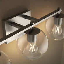 Three-light wall sconce with clear globe glass shades and metal support bars