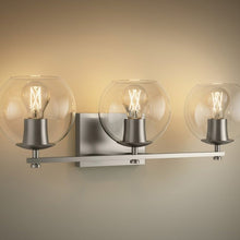 Three-light wall sconce with clear globe glass shades and metal mounting bar