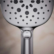 Chrome handshower mode button and nozzle outlets on spray face