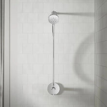 Chrome handheld shower on wall mount with round spray head and hose