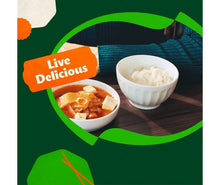 Two meal bowls with cooked sticky white rice and side dishes on package