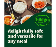 Package art showing bowls of cooked white rice with chopsticks and a spicy side