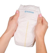 Kudos Size 3 diaper held upright, showing its front and yellow indicator
