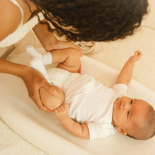 Kudos diaper worn by a baby lying down during a change