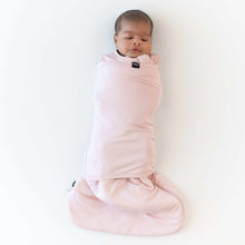 Pink baby sleep bag swaddler on infant, sleeveless with front wrap