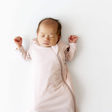 Kyte BABY sleep sack in blush pink on baby, sleeveless with zip front