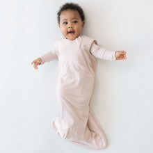 Kyte BABY sleep sack in blush pink on baby, sleeveless and zip-through