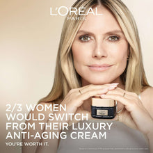 L'Oreal Paris midnight cream jar held in hands by a woman