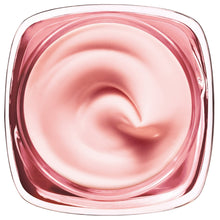 Rosy face cream in open tub with smooth swirl texture