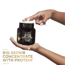 L'Oreal Elvive Power Restore treatment jar with white cap held in hands