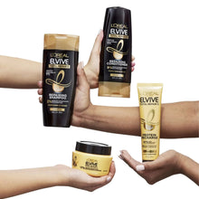 L'Oreal Elvive hair treatment bottles and jar set, held in hands