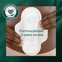 Ultra thin organic cotton pad with wings, white, held by hands, hypoallergenic