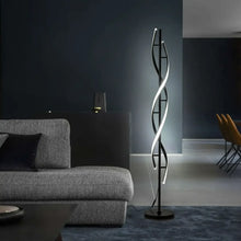 Modern spiral LED floor lamp with curved light bars and slim black pole, standing base