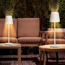 LED touch patio lamp with white shade, lit glow, standing on patio table