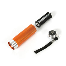Orange LED flashlight with silver front and lanyard strap, plus spare batteries