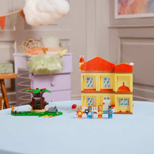 Buildable dollhouse with orange roof and two floors, plus minifigures and garden tree