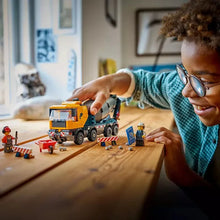 LEGO City cement mixer truck building toy with small parts on a table