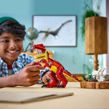 Kids holding LEGO 3-in-1 red dinosaur brick model with white pieces nearby