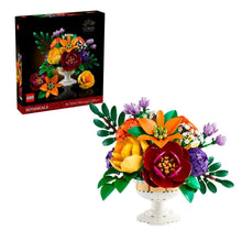 LEGO flower arrangement on a white pedestal stand with multicolor flowers and green leaves