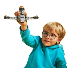 LEGO Star Wars droid mini spacecraft with orange and green details, held aloft by a child