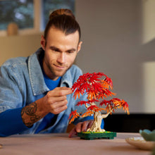 LEGO red maple bonsai tree with red foliage held in hands