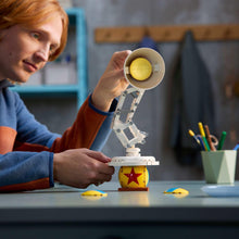 Robotic spotlight model with yellow lamp head and brick base