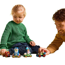 Toy building set with small vehicles and figures on a play mat