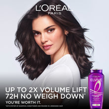 L'Oreal Elvive volumizing conditioner bottle beside model, purple