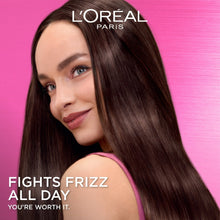 Woman with long straight dark hair, showcasing smooth frizz-free hair finish