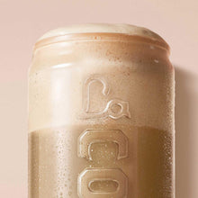La Colombe Draft Latte can close-up with embossed logo and creamy foam texture.