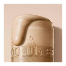Frothy latte with La Colombe logo embossing on coffee can top