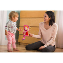 Clip-on plush doll toy with pink hood and multicolor patterned dress, dangling rattle