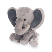 Gray plush elephant toy sitting, head turned, with dark inner ear details.