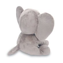 Gray plush elephant toy lying down, with back and large ears visible.