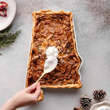 State-shaped bake and serve dish with baked casserole and a serving spoon