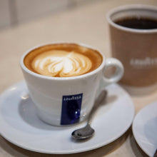 Lavazza espresso coffee cup with latte art in white ceramic