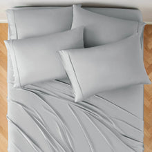 Bamboo rayon sheet set on bed with draped top sheet and three pillowcases
