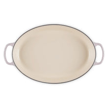 Cast iron oval baker with side handles, cream enamel cooking surface