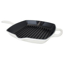 Le Creuset square cast iron grill skillet with black ridged cooking surface and white side handles