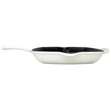 Le Creuset square cast iron grill skillet with white exterior and black ridged cooking surface