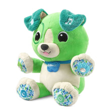 Green plush dog toy with teal musical paw pads and Scout collar badge