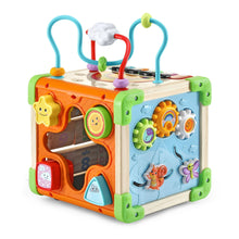 Wooden activity cube toy with orange and blue sides, dials, and hanging handle bars