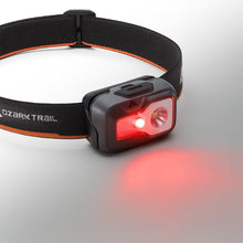 LED headlamp on black-and-orange strap with red beam mode, gray housing
