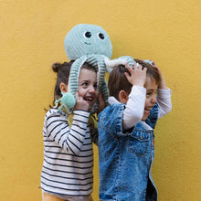 Octopus plush mom with baby attached, held by two children