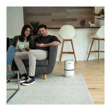 White Levoit personal air purifier, compact cylinder with black base and vented bottom