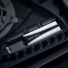Heatsink SSD installed under a console cover, black with silver stripes