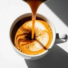 Coffee machine descaler and cleaner shown pouring into a foamy coffee cup