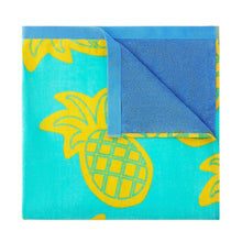 Kids beach towel corner close-up, turquoise pineapple print with blue backing edge