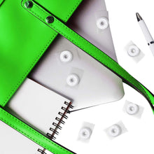 Green and gray notebooks with white mint pieces and a pen