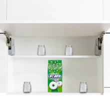 Hard candy mint bag centered on a cabinet shelf among small jars